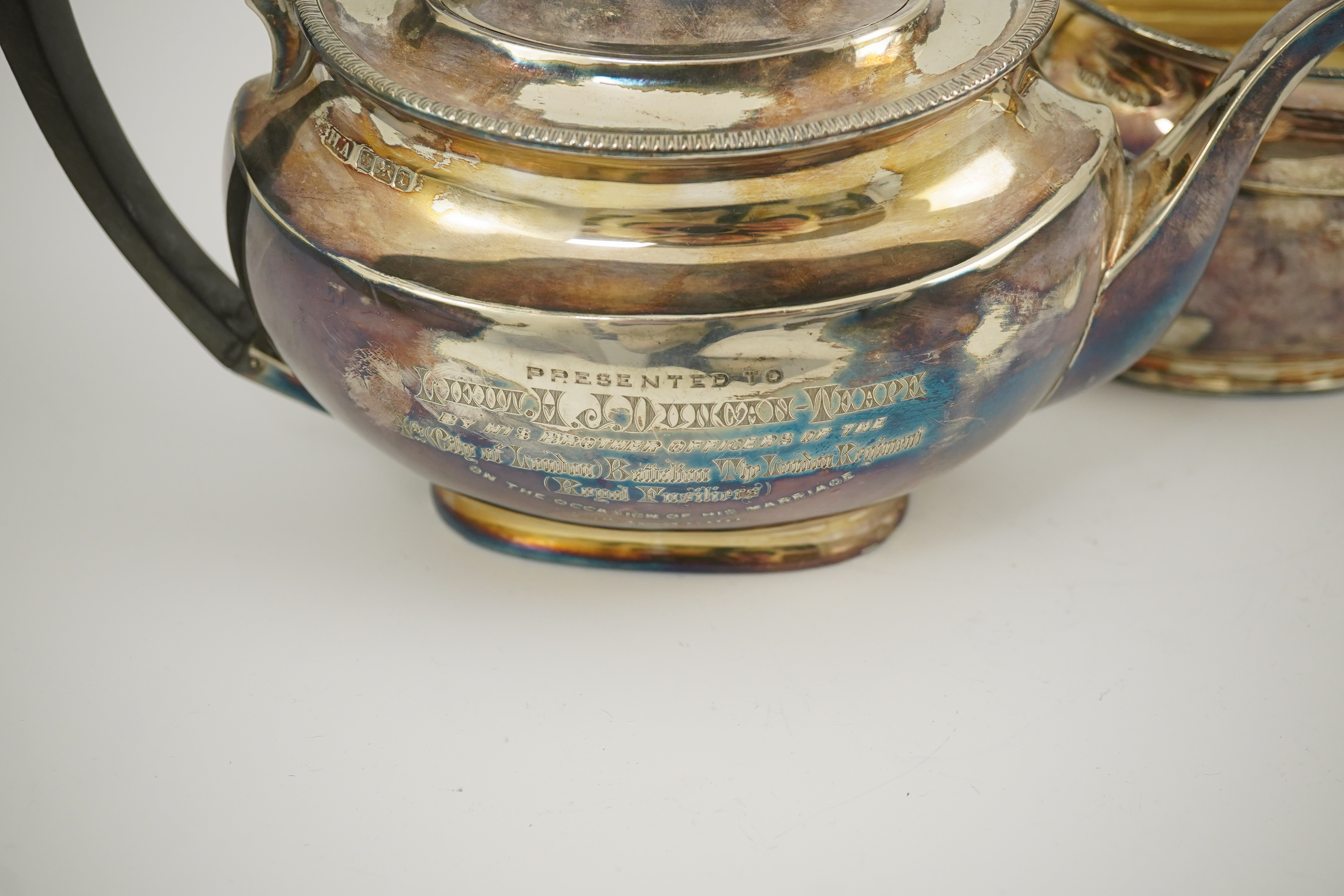 An Edwardian silver teapot and a matching sugar bowl, with engraved inscription, relating to the Royal Fusiliers, by Atkin Brothers